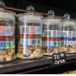 A display case with several jars of food on it.