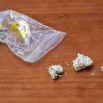 A bag of candy and some pieces on the floor